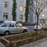 zdjęcie ulicy Jackowskiego po remoncie, na pierwszym planie samochody zaparkowane równolegle do ulicy, w tle budynek Starostwa Powiatowego w Poznaniu